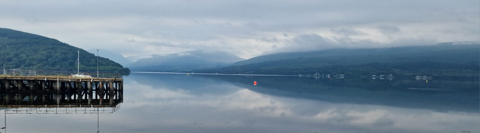 Still loch waters and misted hills of Argyll at dawn